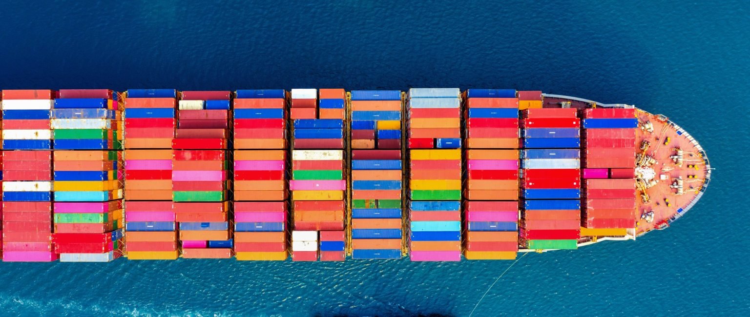 Aerial view of container cargo ship in sea.